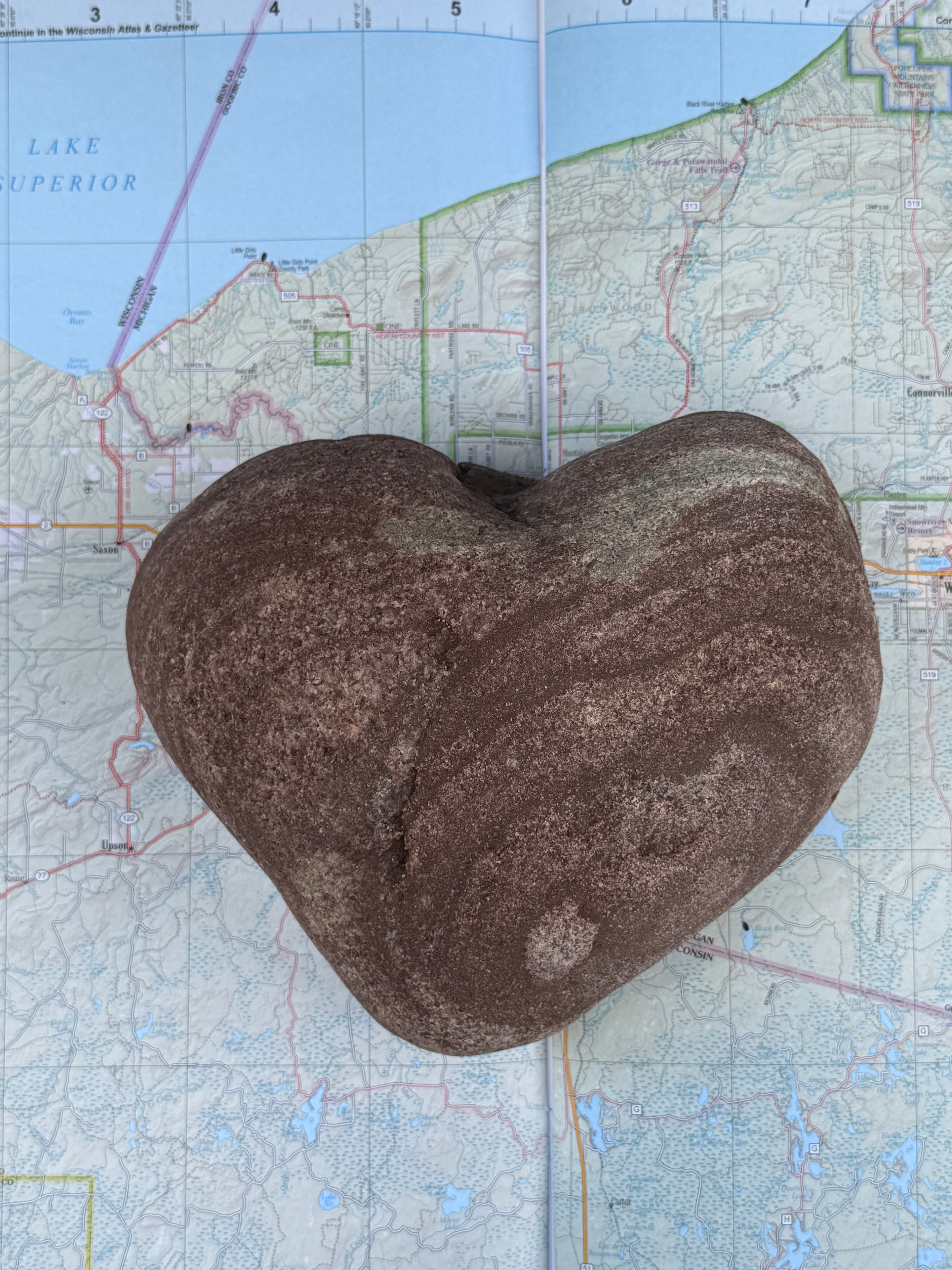 Heart-shaped stone on a map