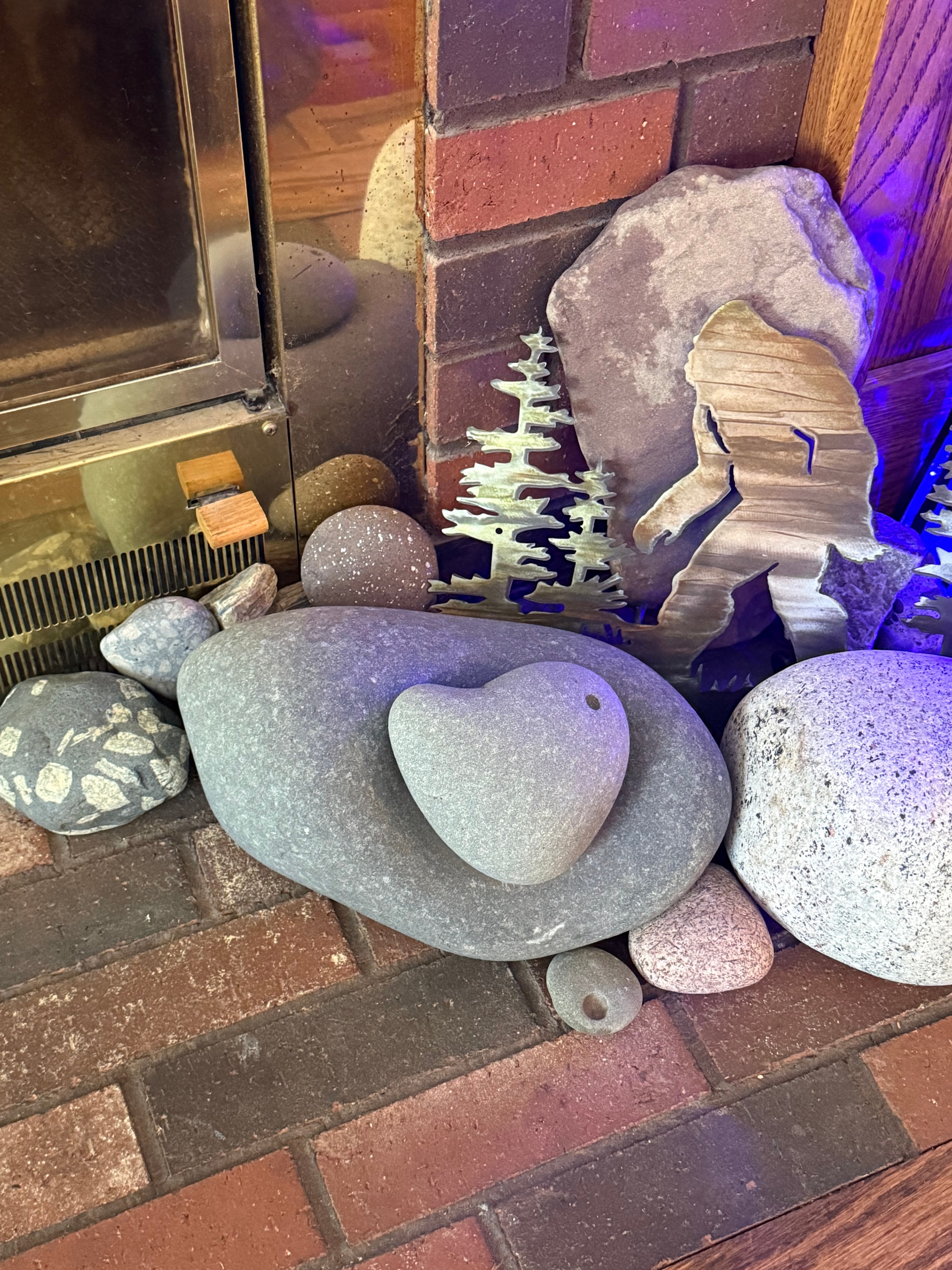 Collection of Lake Superior stones and driftwood by a fireplace