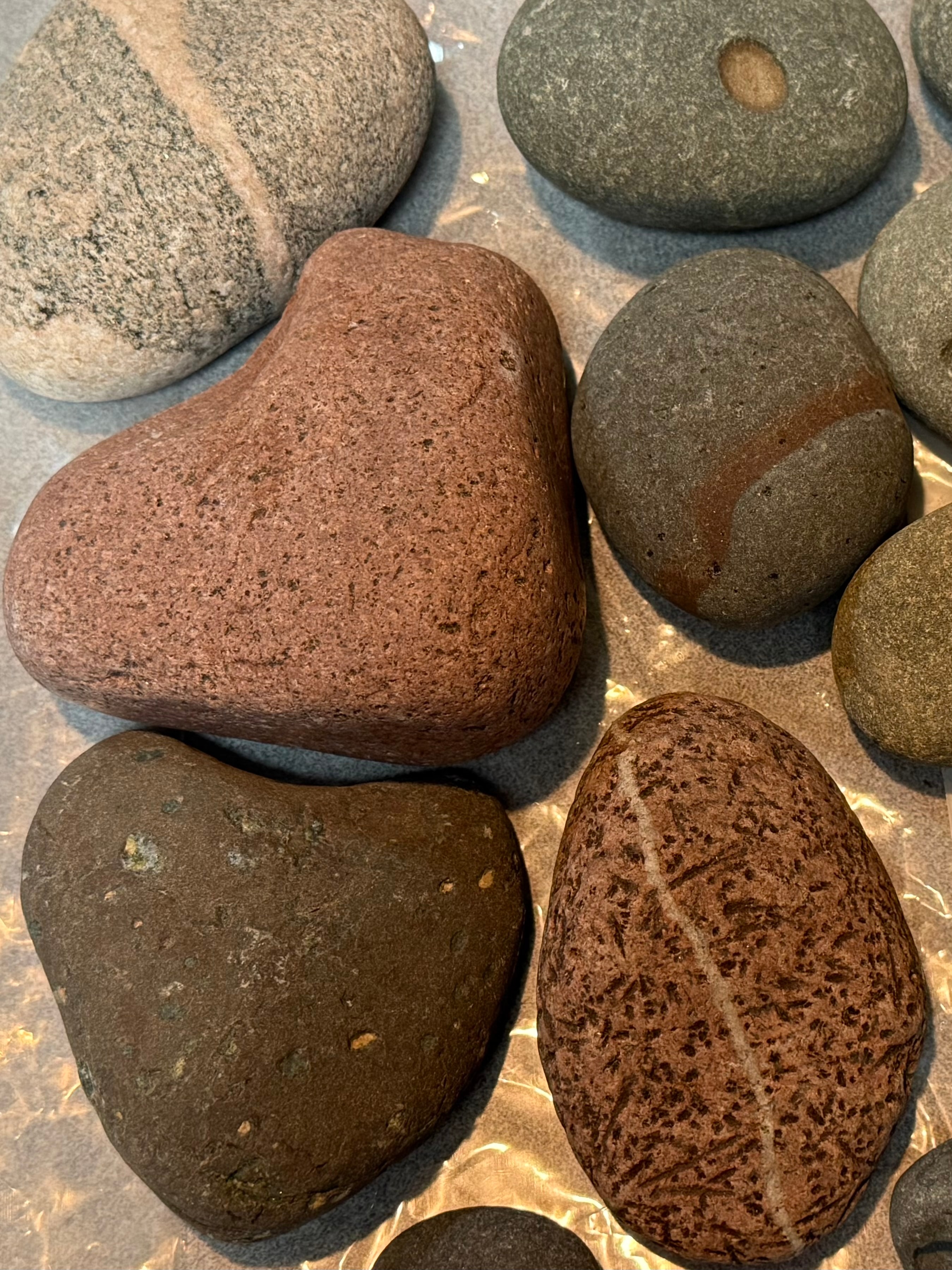 Heart-shaped and striped Lake Superior rocks laid out