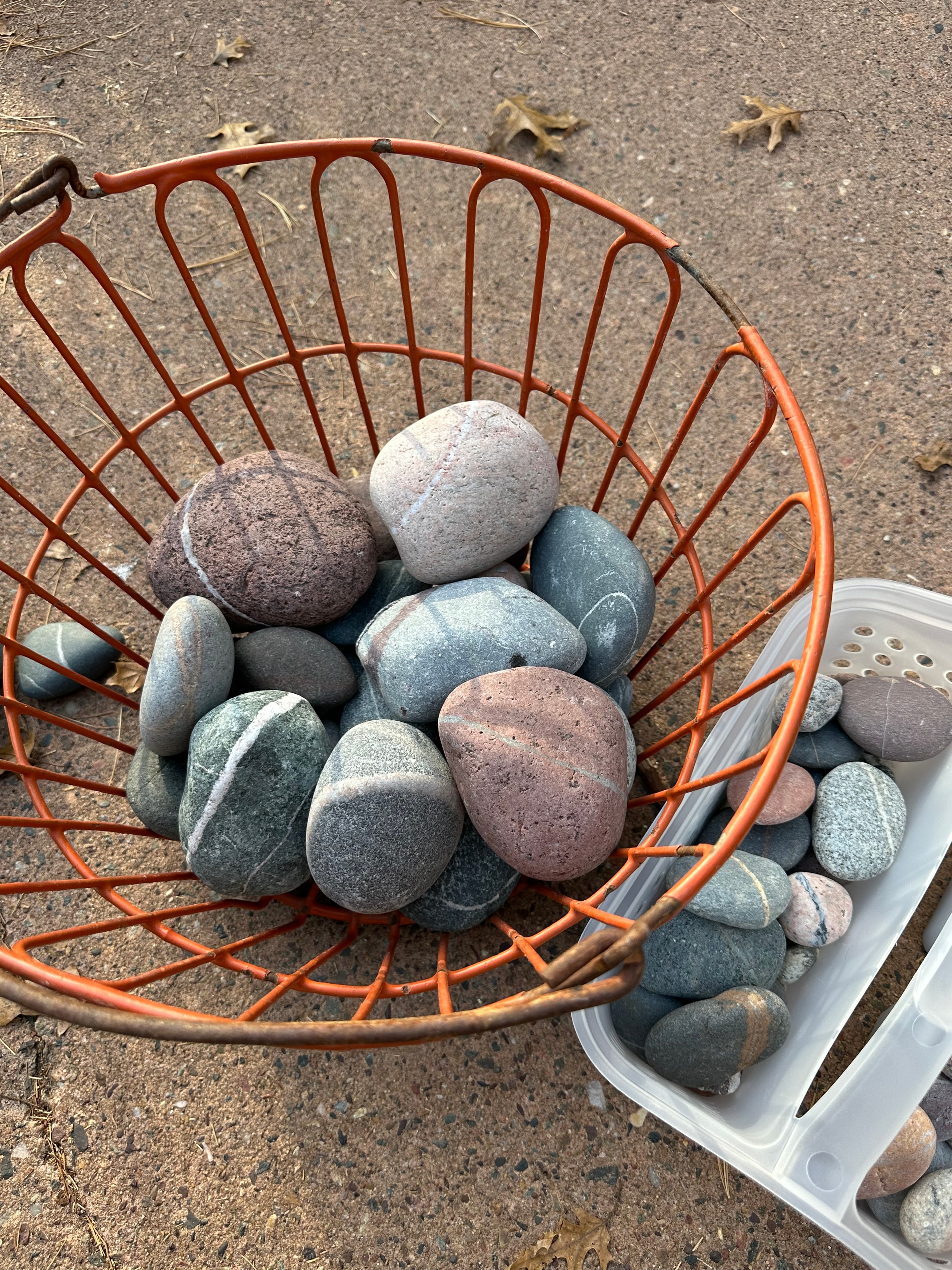 Striped Lake Superior stones in an orange wire basket